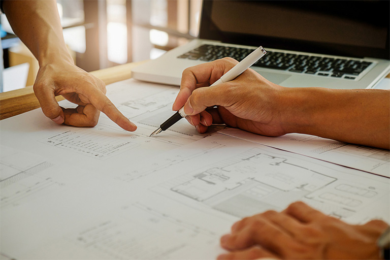 Two individuals  working at a table